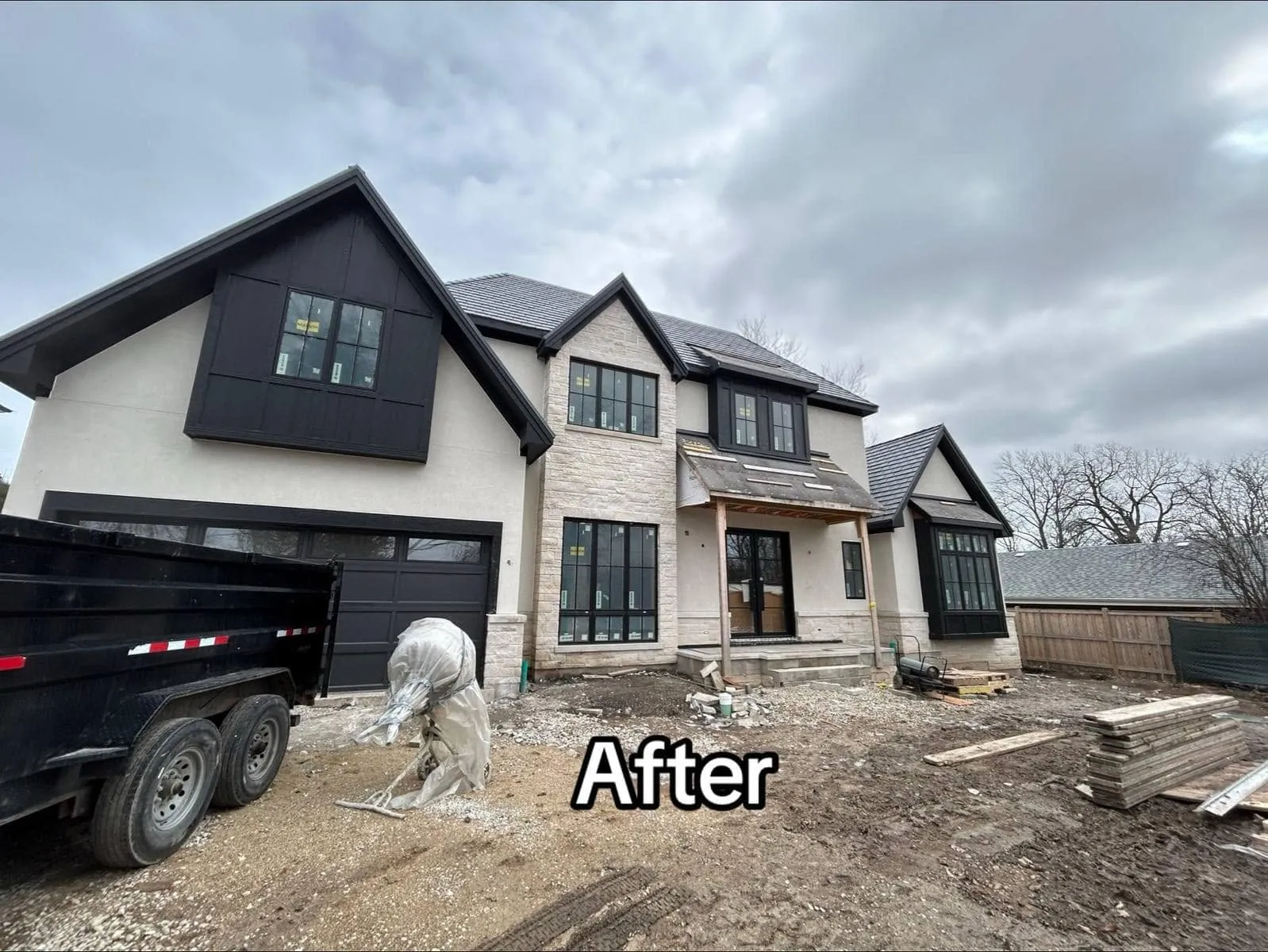 The same home finished: cream stucco upper walls, a dark board-and-batten gable, light stone veneer and black-framed windows